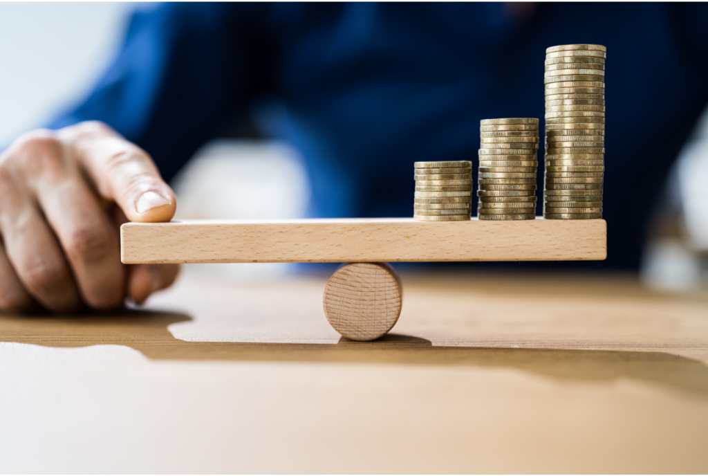 guy balances coins on seesaw